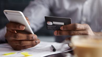 cropped shot of african american businessman paying with credit card online