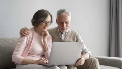 medium shot happy couple with laptop