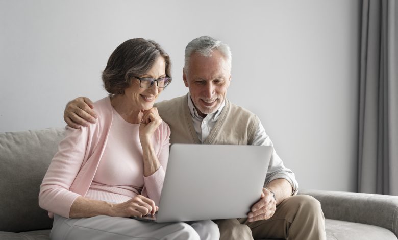 medium shot happy couple with laptop