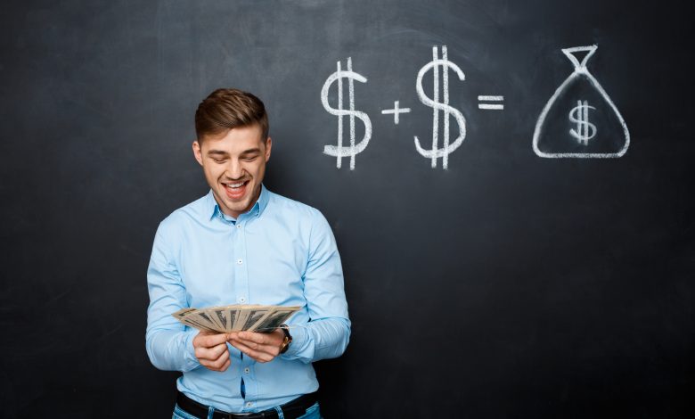 handsome man standing over blackboard with drawn dollar concept