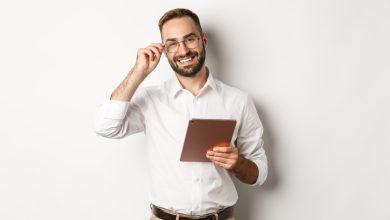 confident business man working on digital tablet smiling happy standing