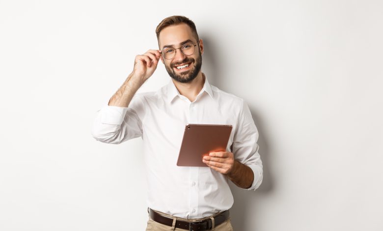 confident business man working on digital tablet smiling happy standing