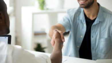 multiracial businessmen shaking hands multi ethnic partnership concept close up view