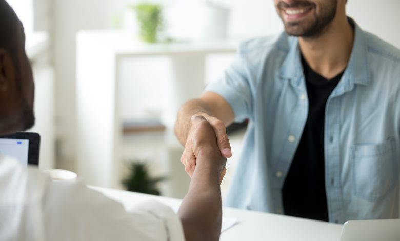 multiracial businessmen shaking hands multi ethnic partnership concept close up view